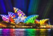 Colourful image projected on the side of the Sydney Opera house during an economical vacation in Sydney.