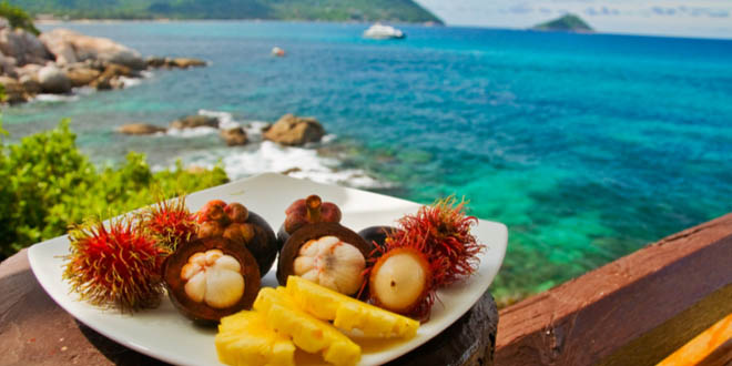 Plateful of exotic foods to try in hawaii with views to the sea