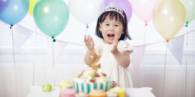 Little girl eating Hello Kitty DIY birthday cakes