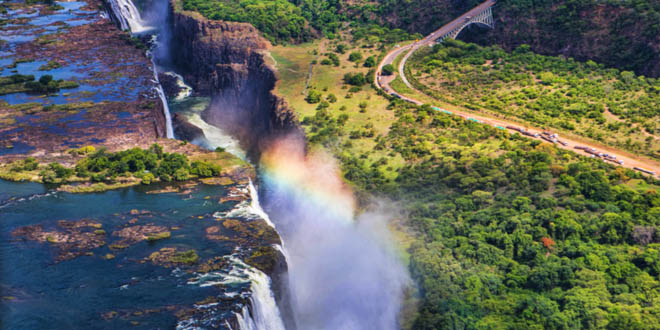 Rainbow over Victoria Falls in Zimbabwe, a must stop during a foodie's day in Harare.