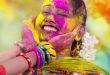 Fun, Food and Festivals in India. Portrait of a young Indian woman celebrating the Holi color festival.