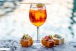 Spritz Aperol drink with traditional cicchetti snacks, some of the best foods to eat in Venice.