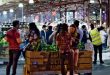 Shoppers enjoying a summer night at Queen Victoria Market, one of the best food markets in Melbourne.