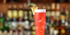 Singapore sling cocktail in a tall glass at the Long Bar of the Raffles Hotel